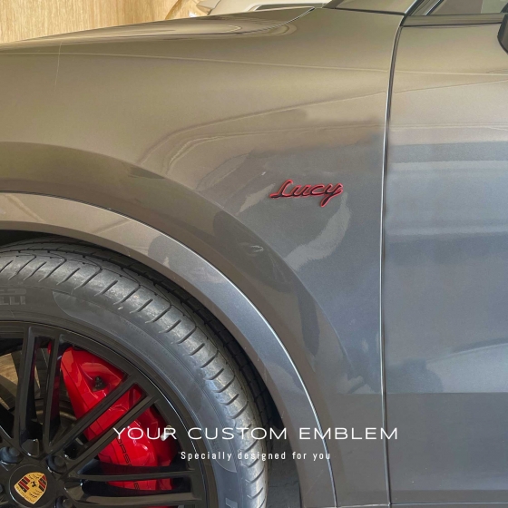Lucy black with red background painted Emblems installed on the Porsche Cayenne turbo