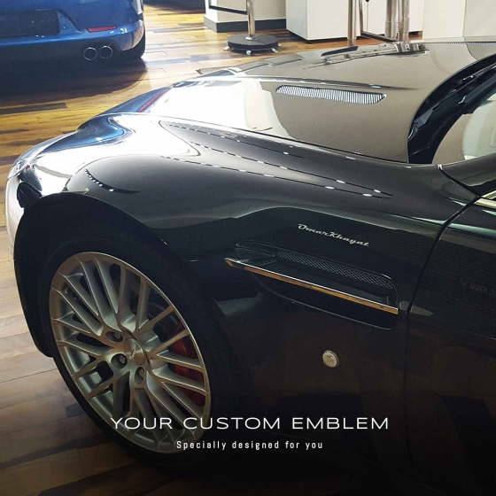 Omar Khayat's Emblem on his Aston Martin